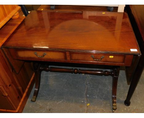 A reproduction Regency flame mahogany sofa table.