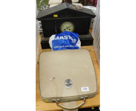 A 'Diplomat Super', portable manual typewriter, in carry case, together with a French slate mantel clock, displaying Arabic n