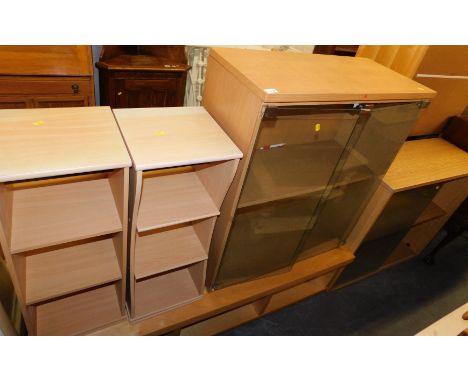Various modern light wood furniture, including an Ikea trolley television stand, pair of bedside bookcases, and two glazed ca