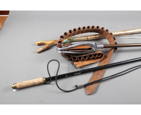 A shooting stick, a cartridge belt and two walking sticks 