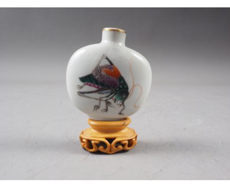 A Chinese porcelain snuff bottle, decorated crickets, seal mark to base, on wooden stand, 2 1/4" high 