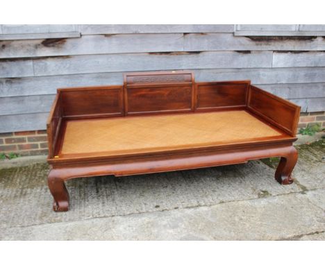 A Chinese hardwood&nbsp;(huanghuali) bed, with woven bamboo seat, on scroll supports, 77" long x 36" wide x 33" high 