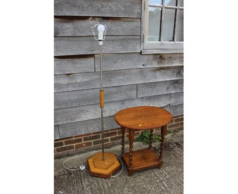 A mid 20th century oak and copper mounted standard lamp, on hexagonal base, 52" high, and an oval oak two-tier occasional tab