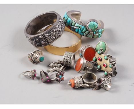 A tribal white metal bangle, set turquoise, a similar fruit embossed bangle and a number of white metal rings 