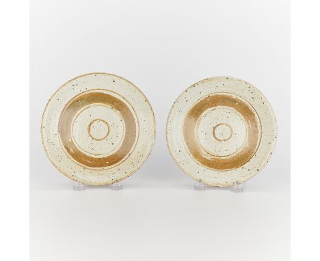 Warren MacKenzie (American, 1924-2018). Set of two studio ceramic plates. Each stoneware plate is with a shino glaze and conc