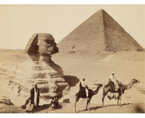 Early 20th century albumen photograph print depicting figures posing on camelback in front of the Great Sphinx and the Great 