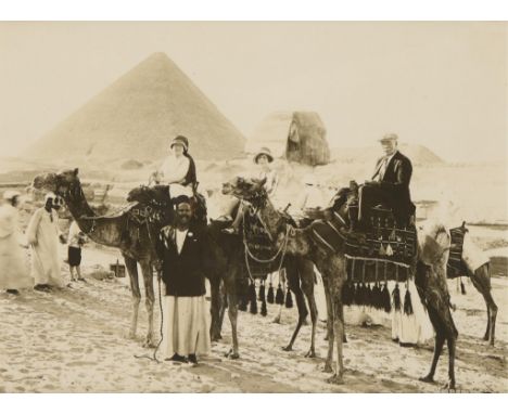 Late 19th century albumen photograph print depicting three figures atop camels posing in front of the Great Sphinx and the Gr