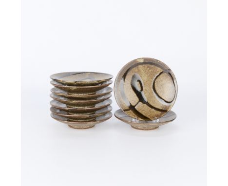 Tatsuzo Shimaoka (Japanese, 1919-2007). Group of nine small studio ceramic plates, 20th century. Stoneware of an iron-saturat