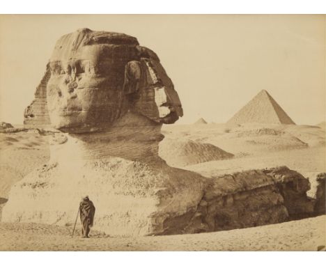 Late 19th century albumen photograph print depicting a man with a cane posing in front of the Great Sphinx and the Great Pyra