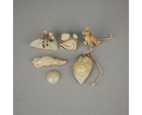 Group of six carved Chinese jades in the form of various floral forms and fruit.Height ranges from 1/4 in to 3/4 in; width ra