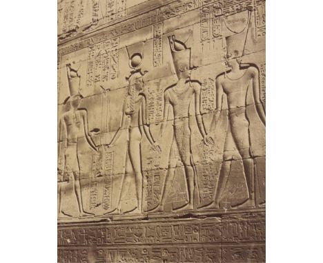 Late 19th century albumen photograph print depicting bas relief hieroglyphics along a wall in Egypt. The left-most figures de