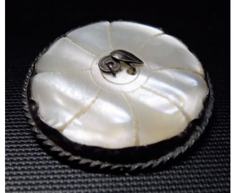Silver and mother of pearl circular brooch, the centre inset with leaf decoration, possibly by Mumford of Falmouth, diameter 