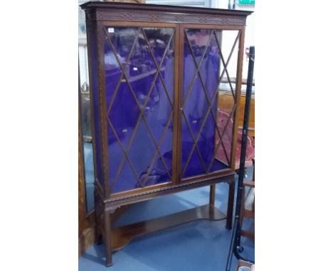 An early 20th Century mahogany display cabinet in Chippendale style by Jas. Shoolbred & Co, Tottenham Court Road, London, ivo