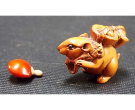 Small Japanese Boxwood Netsuke in the form of a mouse carrying a basket together with a little seed pod and stopper