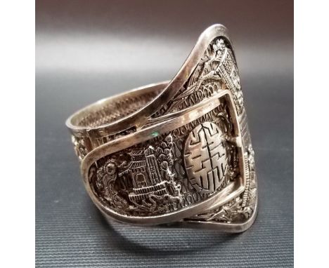Chinese silver filigree buckle form bracelet, applied with scenes of buildings and figures amongst foliage and with prosperit