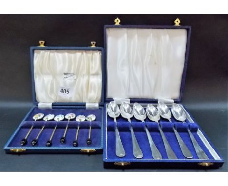 Set of six gilded coffee bean spoons with foliate decorated enamel bowls, boxed; together with a cased set of five silver pla