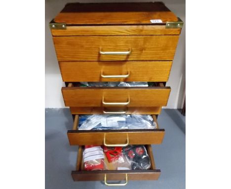 A modern brassbound teak seven drawer chest containing a quantity of vintage Meccano parts and accessories 