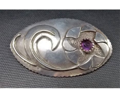 White metal mid-Century oval stylised flower brooch inset with an amethyst, length 6.25cm approx, weight 22.3g approx.