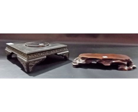 Chinese ebonised square section stand, the sides foliate scroll carved; together with a root carved stand, width 12.5in.