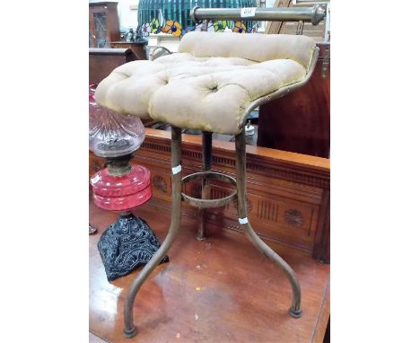 Edwardian brass adjustable organ stool with tubular backrest over a button back upholstered seat and raised on three legs, re