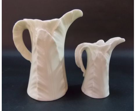 Graduated pair of Royal Worcester leaf moulded cream jugs, the largest height 4.75in