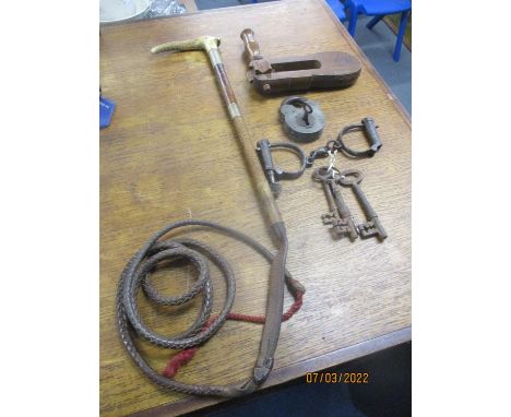 A group of items to include a wooden police rattle with impressed initials, and iron police handcuffs, a padlock with key, a 
