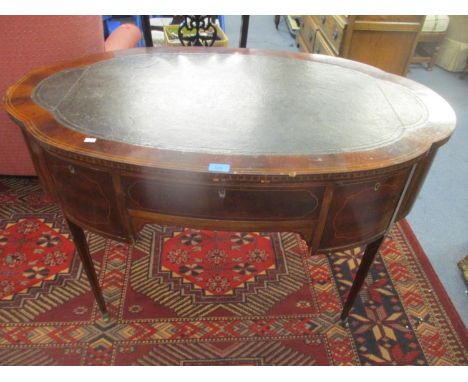 An Edwardian inlaid mahogany writing desk with inset green tooled scriber, central drawer flanked by two short drawers, on sq