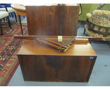 A mid 20th Century wall hanging rosewood modular record cabinet with internal shelf divides, a key and drop down front 