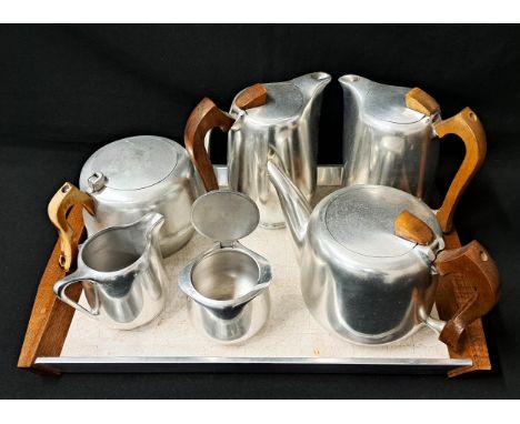 PIQUOT WARE TEA/COFFEE SETcomprising two coffee pots, two tea pots (one missing finial), milk jug, sugar bowl and tray