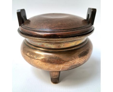 CHINESE BRONZE SHI SHOU CENSERwith a compressed circular body with incised silver inlaid decoration, raised on three stout su