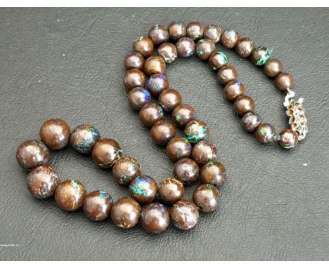 VINTAGE STRING OF BLACK OPAL BEADS48 in total, the largest bead 8mm in diameter, total length 40cmPurchased from South Africa