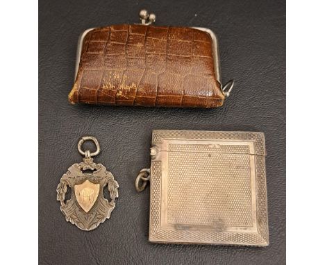 SILVER CARD CASEwith engine turned decoration, Birmingham hallmarks for 1945; together with a silver medal fob and a leather 