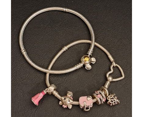 SELECTION OF PANDORA SILVER JEWELLERYcomprising a Moments heart snake chain bracelet with five enamel and gem set Pandora cha