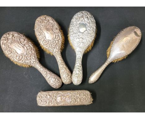 SELECTION OF SILVER BACKED BRUSHEScomprising a pair of brushes with scroll and floral embossed backs, Chester 1908; one with 