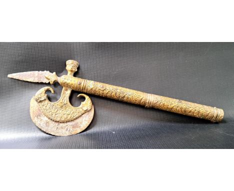 INDO PERSIAN CEREMONIAL AXE HEADin iron and brass with elaborate relief decoration and an engraved crescent blade, 39.5cm hig
