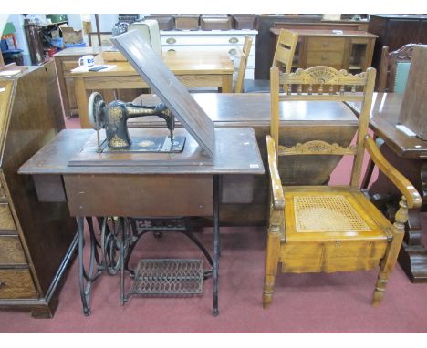 A Jones Treadle Sewing machine, plus commode chair. (2).