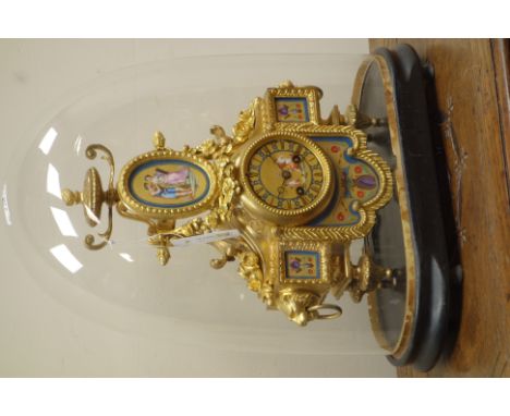 Late 19th century French ormolu mantle clock, decorated with floral swags and serves style panels, lion mask handles, on ebon