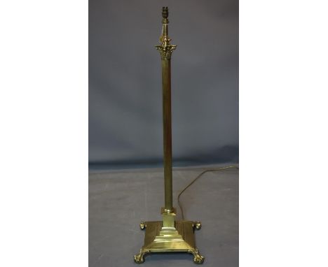 A Victorian cast brass Corinthian column standard lamp, raised on stepped square base with lion paw feet, H.134cm 