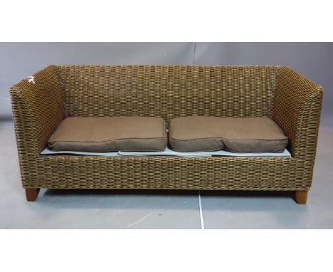 A three seater cane sofa, H.74 W.176 D.76cm, with two associated cushions 