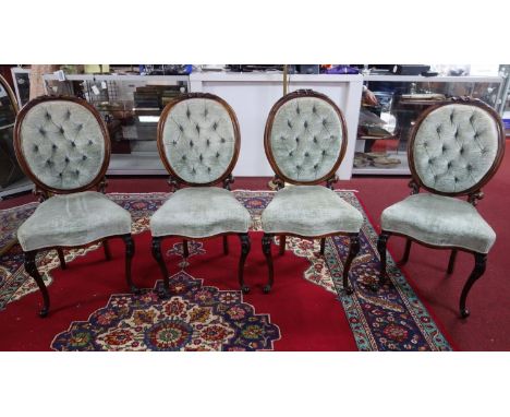 A set of four Victorian rosewood balloon back dining chairs, with button back velour upholstery 