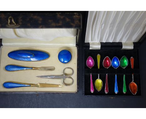 A boxed set of 6 silver plated and guilloche enamel spoons, together with a boxed guilloche enamel manicure set 