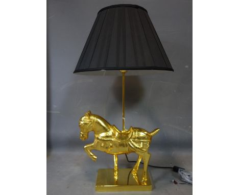 A gilt painted metal horse table lamp, with black shade, H.82cm 