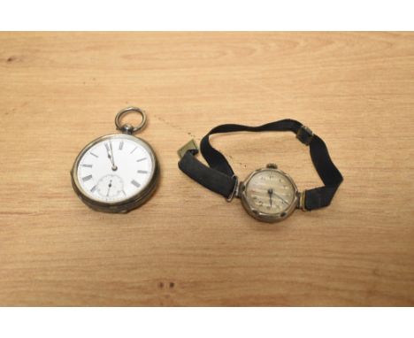 A silver open face pocket watch, the white dial with Roman numerals and subsidiary dial at 6, the case having ornate foliage 