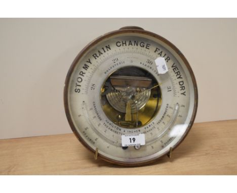 An early 20th century French made brass-cased combination barometer/thermometer, of circular form with ring suspension, and h