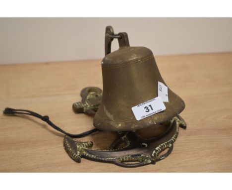 A vintage cast-brass maritime/nautical themed bell, with rope and anchor shaped bracket 19cm