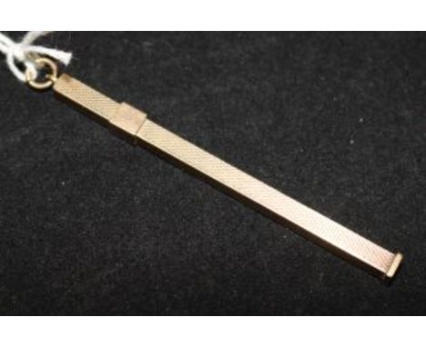 An engine turned 9ct gold swizzle stick, 2.75in.