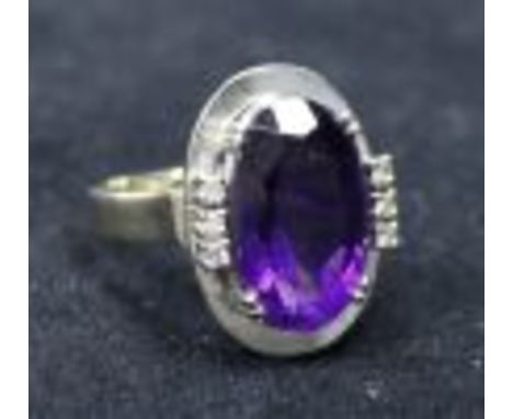 A 14k gold, amethyst and diamond set oval dress ring, size M.