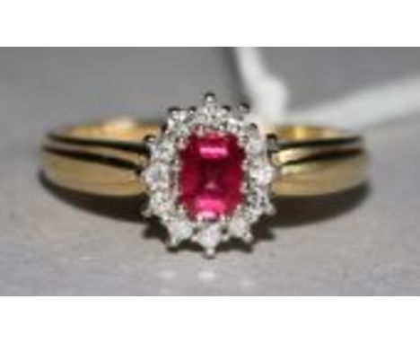 An 18ct gold, ruby and diamond cluster ring, size M.