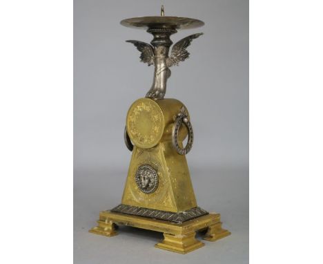 An Empire style ormolu candlestick