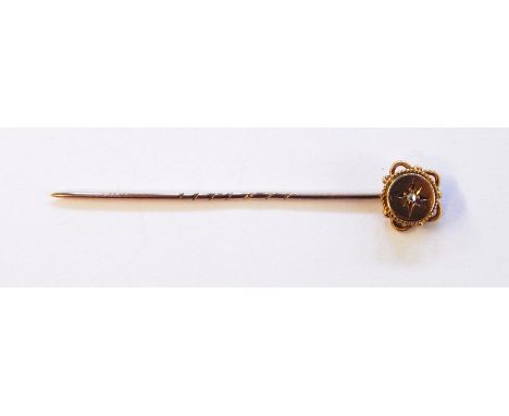9ct gold and diamond stick pin, the central rose-cut diamond inset star, in circular terminal, surrounded by rope-twist and l